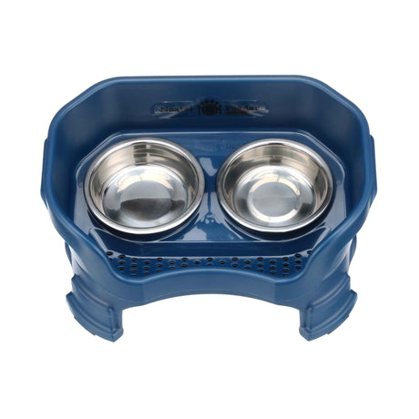 Photo showing drainage holes in a dark blue small neater feeder top view with two stainless steel bowls against a white background.