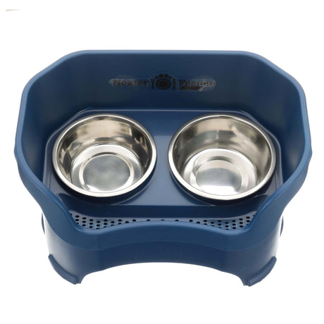 Photo showing drainage holes in a dark blue large neater feeder top view with two stainless steel bowls against a white background.