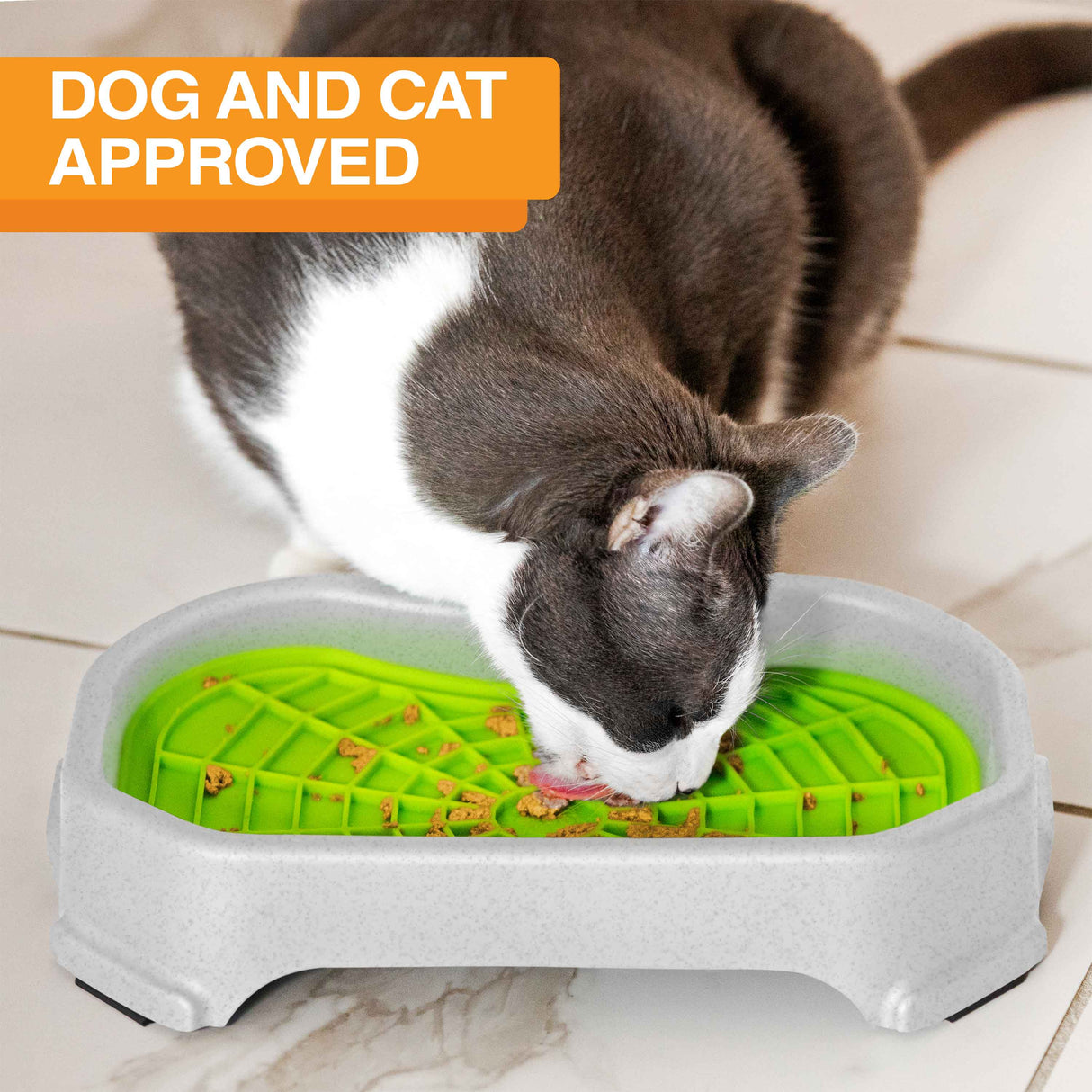 Cat licking food out of the Neat-Lik Mat Slow Feed Licking Mat with the base with text that says "Dog and cat approved."