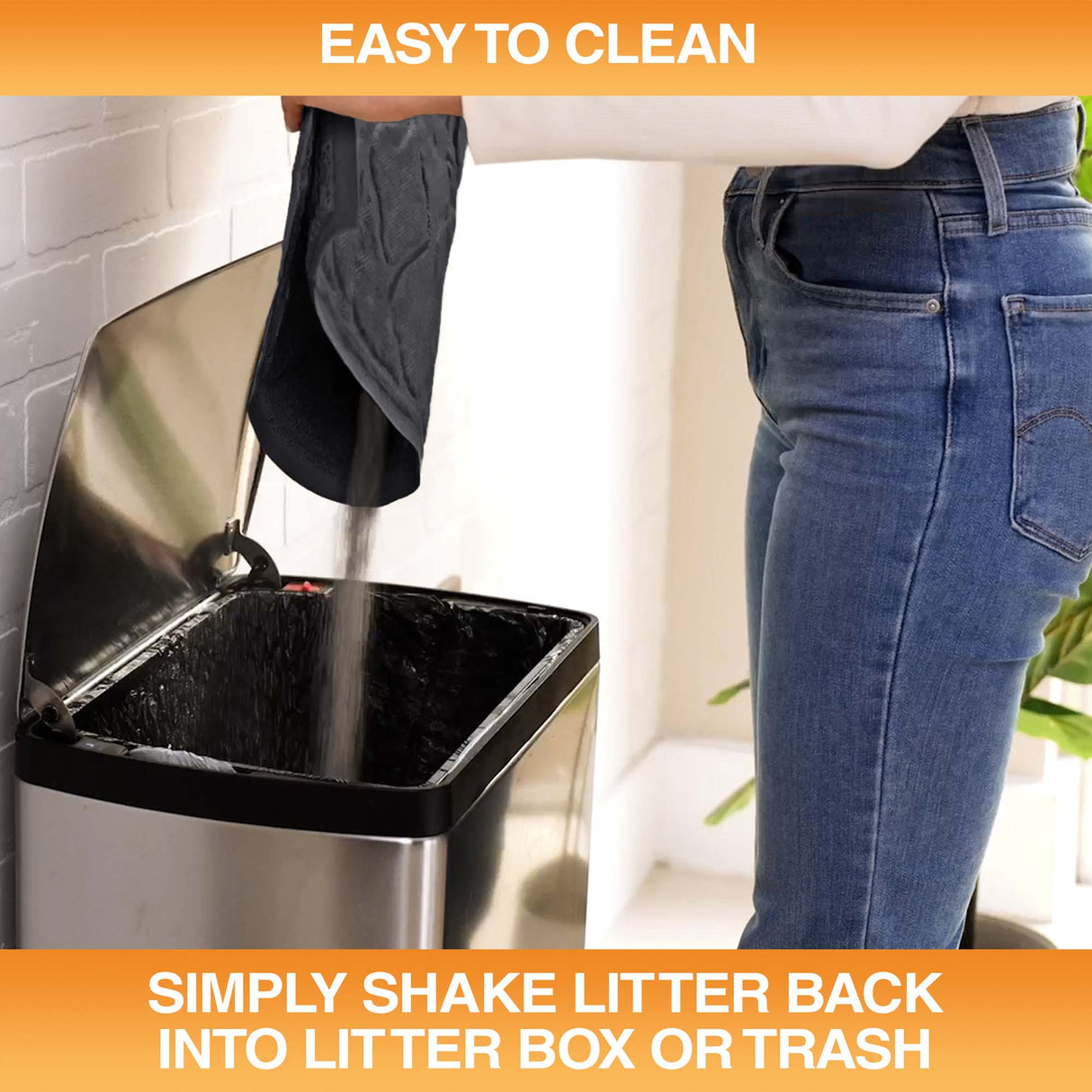 Woman pouring litter caught by the mat into a trash can