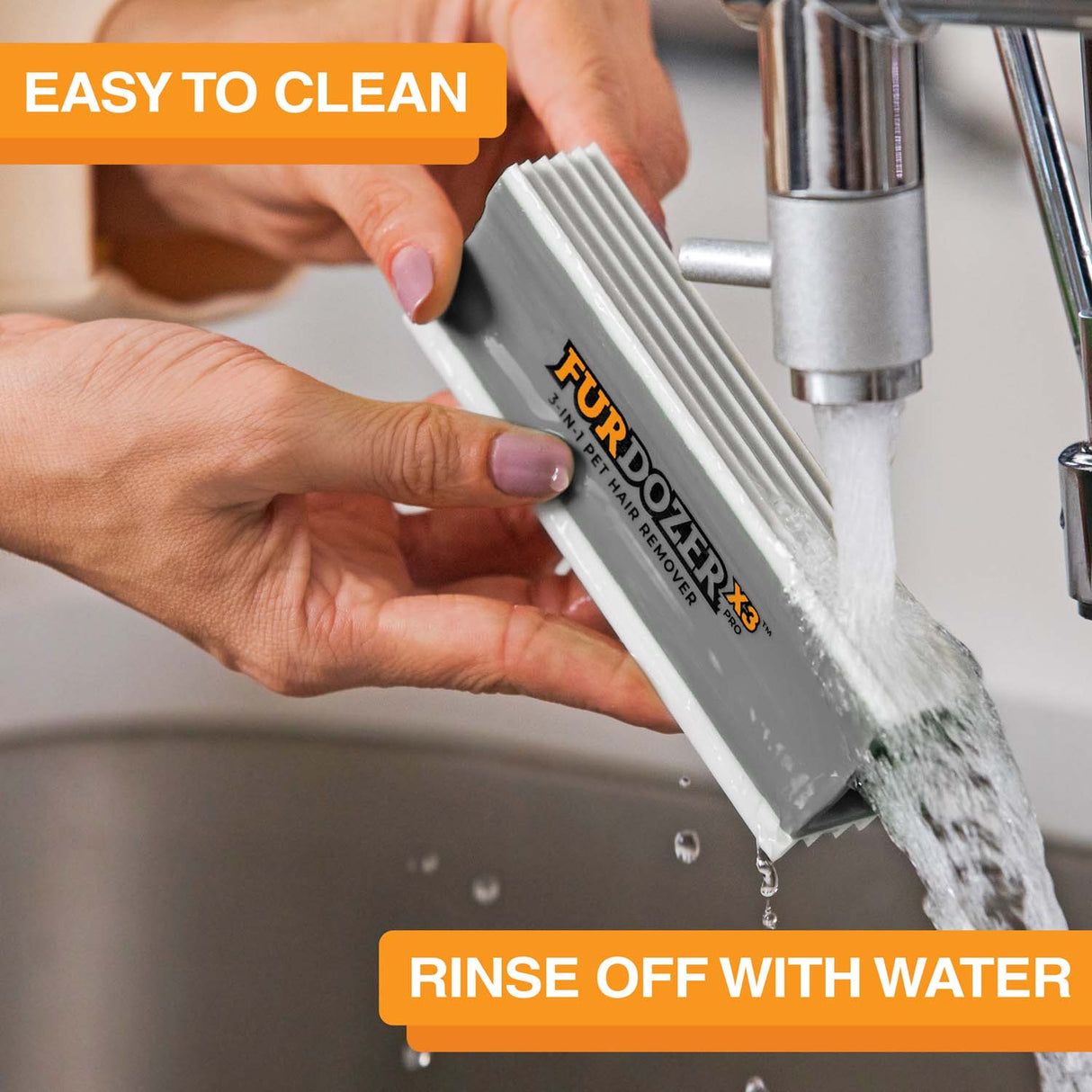 FurDozer is being cleaned in a sink with water coming out of the spicket. Text on screen reads: Easy to clean. Rinse off with water.