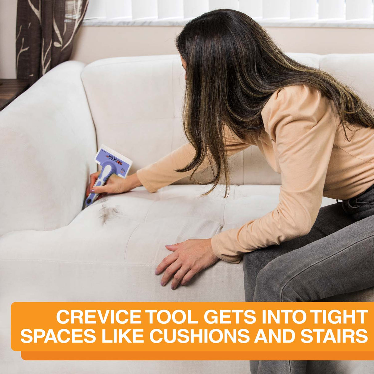 Picture of a woman cleaning the crevice of the couch with the FurDozer X6. Text on screen reads: crevice tool gets into tight spaces like cushions and stairs.