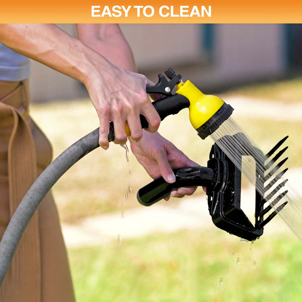 A person cleaning the top of the Lift N' Bag with a hose. Text on screen reads: Easy to clean.