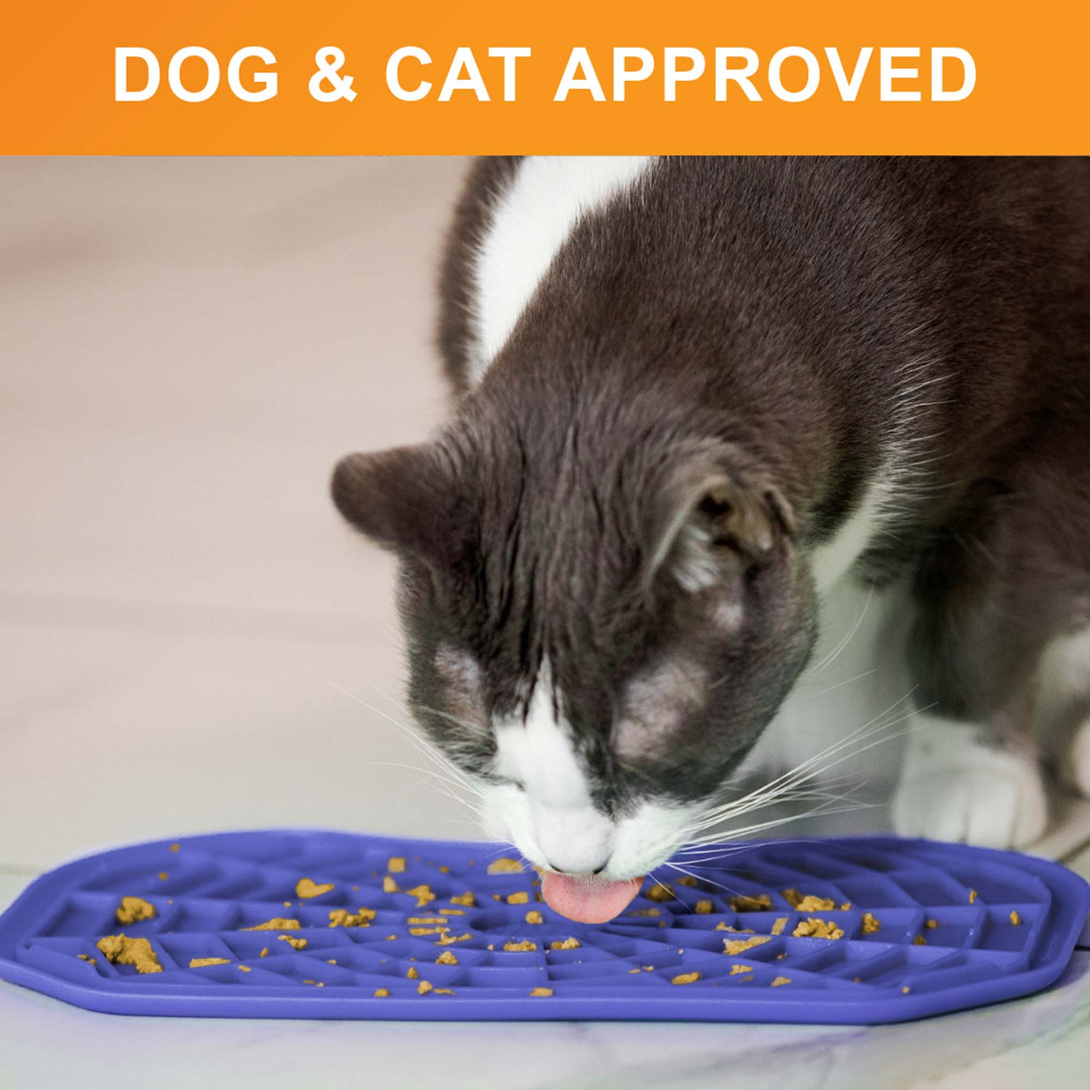 Cat licking food out of the Neat-Lik Mat Slow Feed Licking Mat directly on the ground with text that says "dog and cat approved."