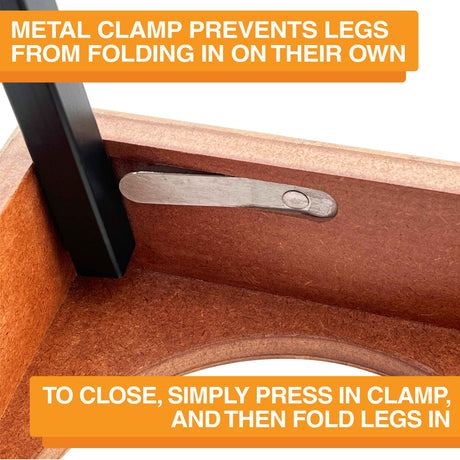 A close-up of the metal clamp on the underside of the feeder. Text on screen reads: Metal clamp prevents legs from folding in on their own. To close, simply press in clamp, and then fold legs in.