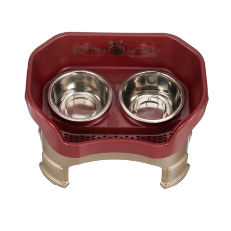 Deluxe medium Neater Feeder in Cranberry with leg extensions top view with two stainless steel bowls against a white background.
