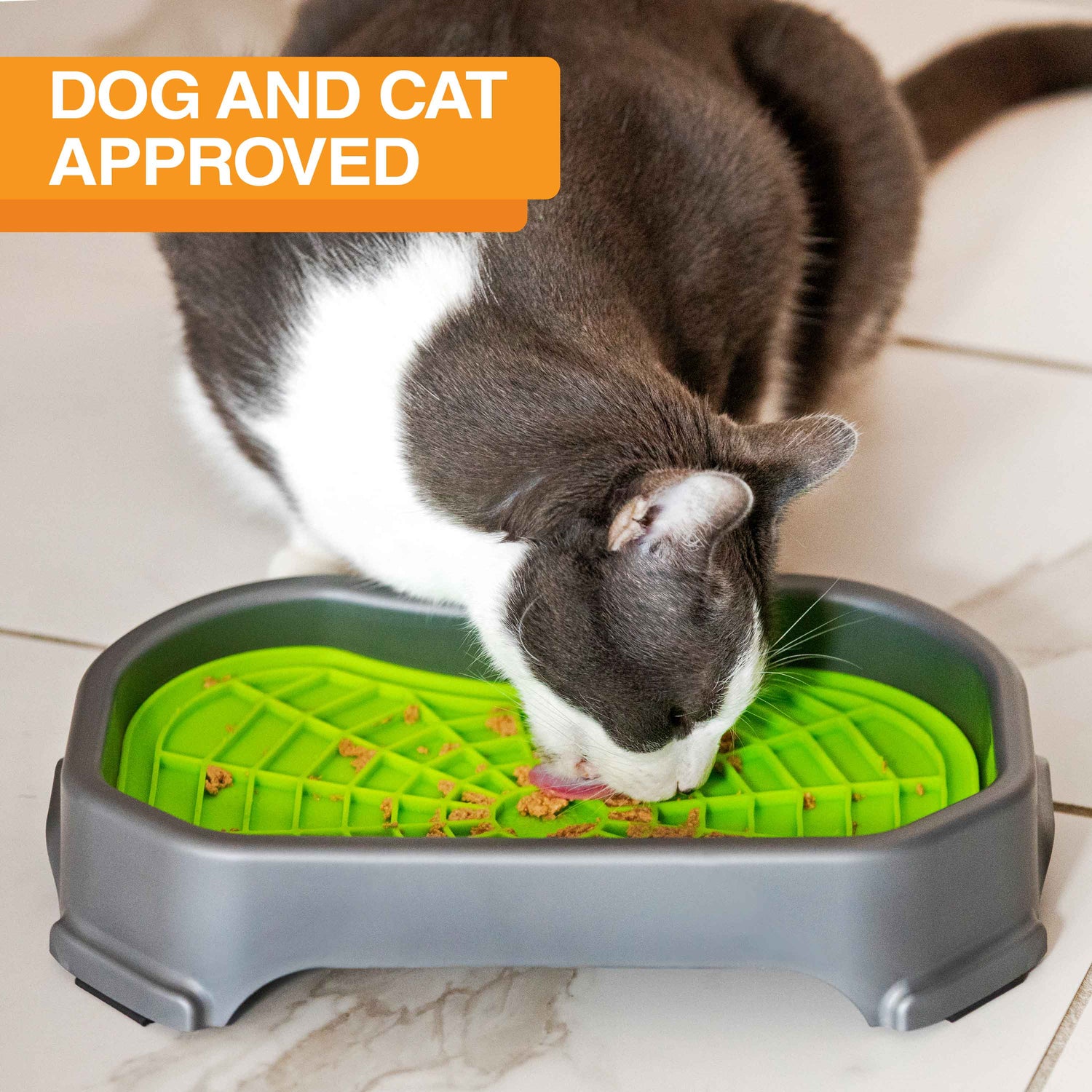 Cat licking food out of the Neat-Lik Mat Slow Feed Licking Mat with the base with text that says "Dog and cat approved."