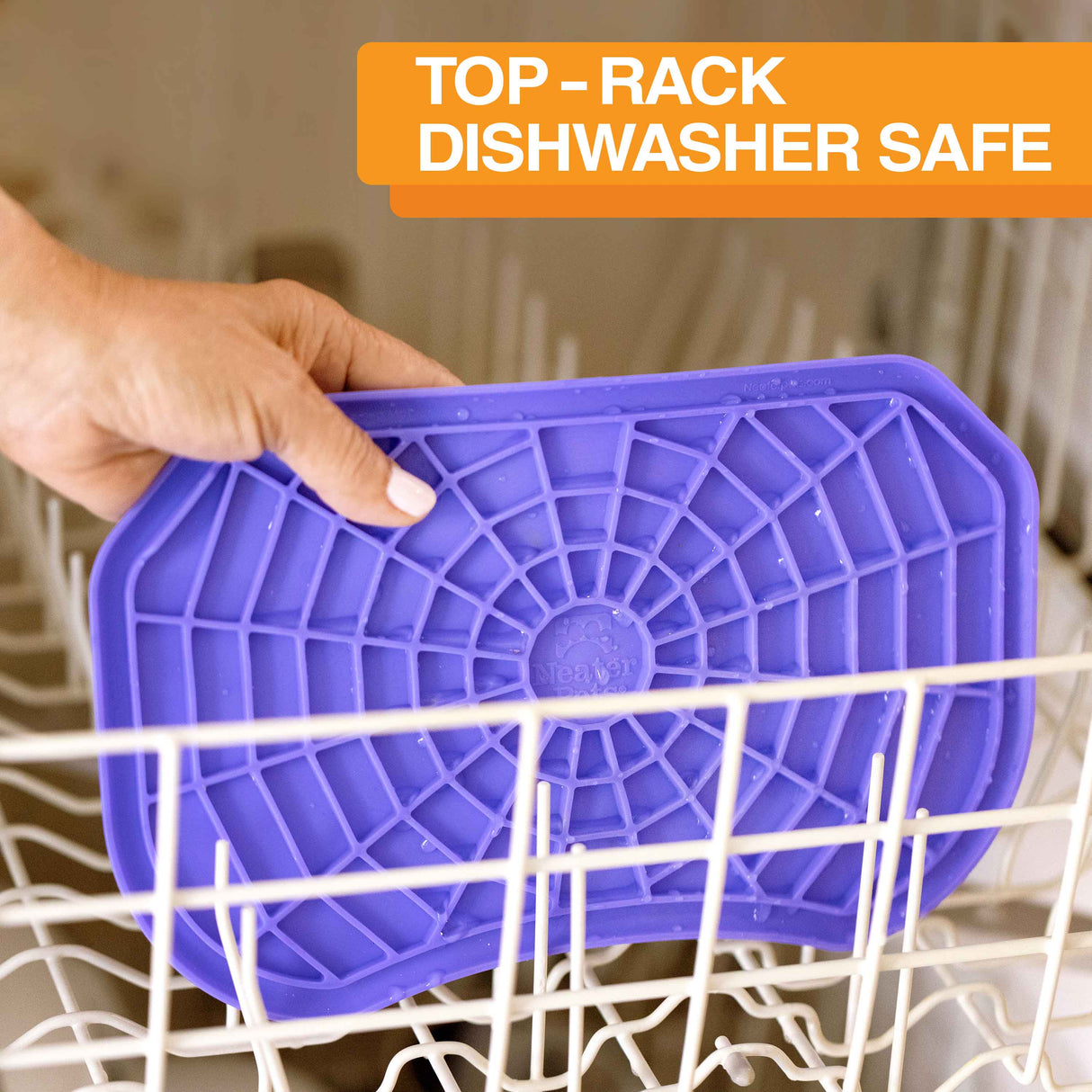 The Neater Pets Neat-Lik Mat being placed on the top rack of the dishwasher