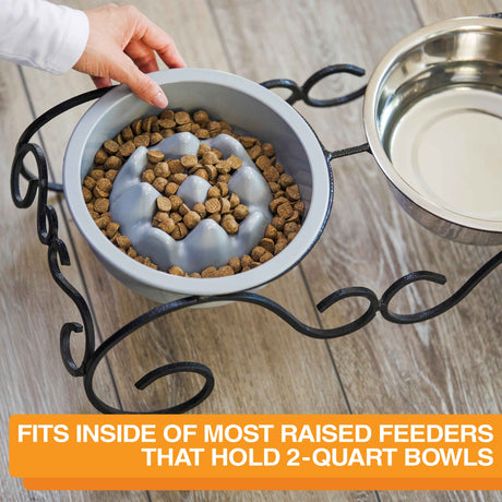 Woman placing The Niner inside the Wrought Iron feeder with text that says the bowl can fit into most raised feeders that hold 2-quart bowls.
