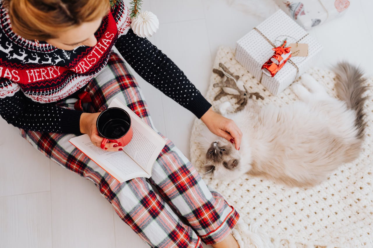 Woman reading a book with a cat