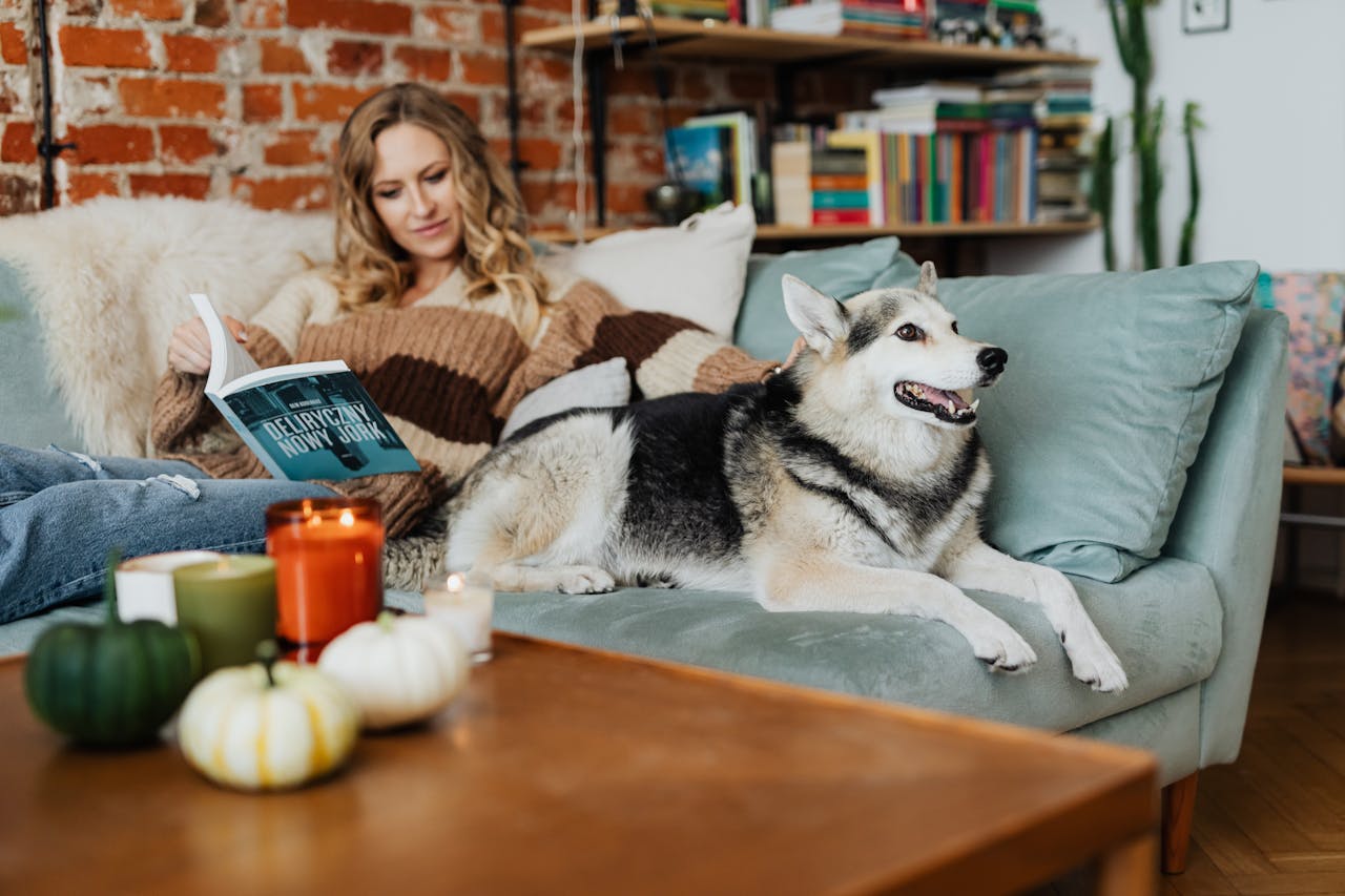 Woman sitting on a couch with a dog