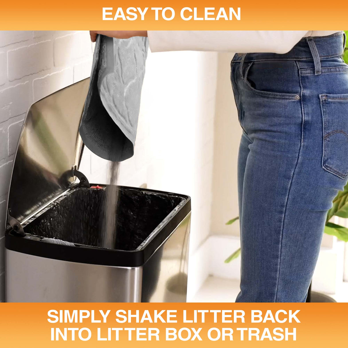 Woman pouring litter caught by the mat into a trash can