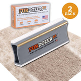 FurDozer X4 Pet Hair Remover and Lint Remover tool shown in front of its retail box on a beige shag rug with a streak of clean carpet under the FurDozer. There is an icon saying that it is a 2 pack. The FurDozer is a gray color.