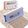 FurDozer X4 Pet Hair Remover and Lint Remover tool shown in front of its retail box on a beige shag rug with a streak of clean carpet under the FurDozer. The FurDozer is a light purple/lavender color.