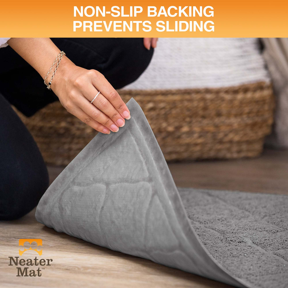 Gray mat with non-slip backing being rolled out on a wooden floor, Neater Mat brand visible.