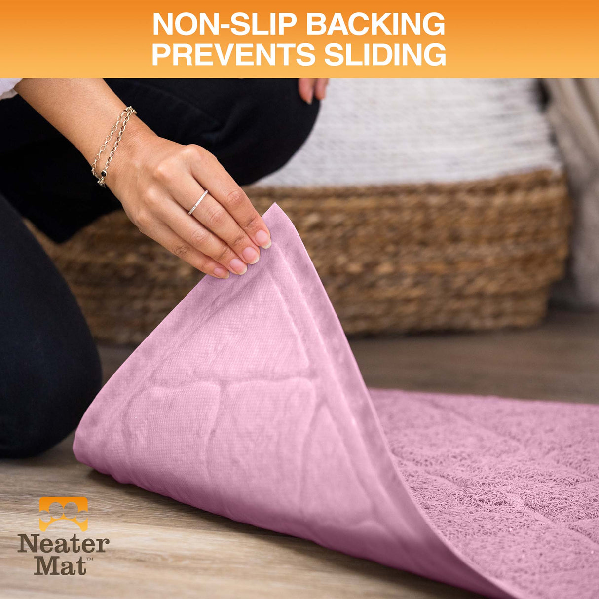 Pink mat with non-slip backing being rolled out on a wooden floor, Neater Mat brand visible.