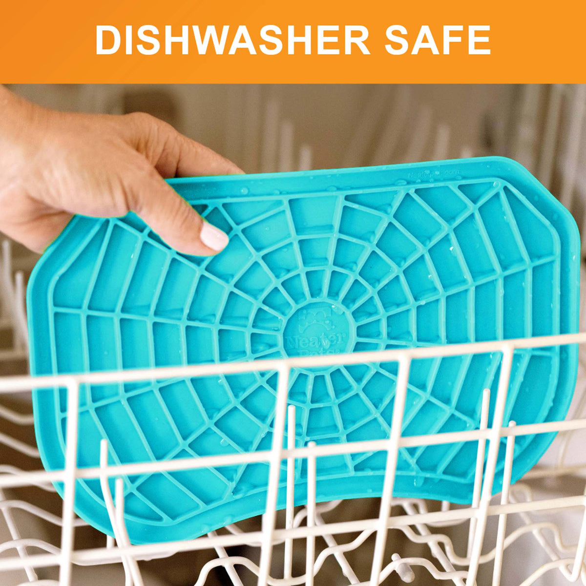 Dishwasher safe: a hand places the aquamarine Neat-Lik Express licking mat on the top rack of a dishwasher