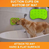 Suction cups on the bottom of the green Neat-Lik Express licking mat attach it to any hard, flat surface, here a bathtub wall for a golden retriever