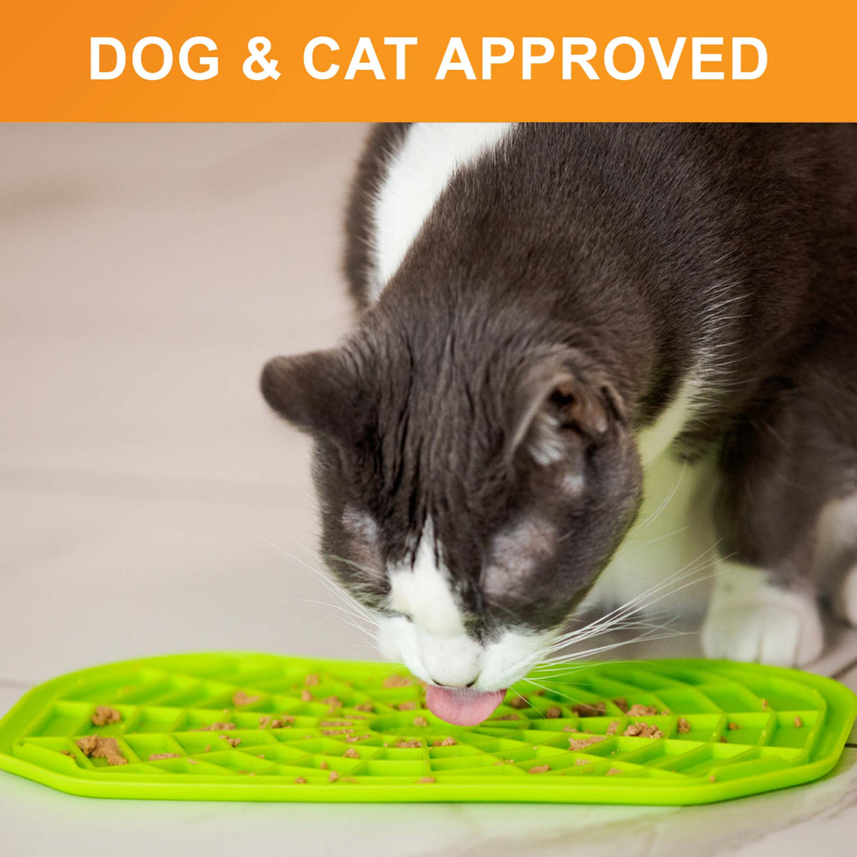 Cat licking food out of the Neat-Lik Mat Slow Feed Licking Mat directly on the ground with text that says "dog and cat approved."