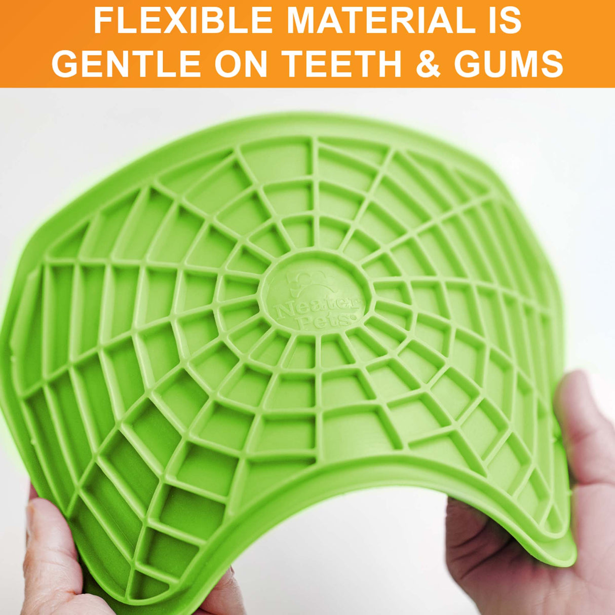 The Neat-Lik mat being spread apart to show the flexibility of the mat with the text "flexible material is gentle on gums and teeth."