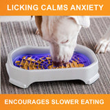 Dog licking peanut butter from the purple Neat-Lik Mat Slow Feed Licking Mat with text that reads "Encourages slow eating and reduces anxiety."