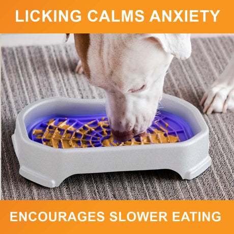 Dog licking peanut butter from the purple Neat-Lik Mat Slow Feed Licking Mat with text that reads "Encourages slow eating and reduces anxiety."