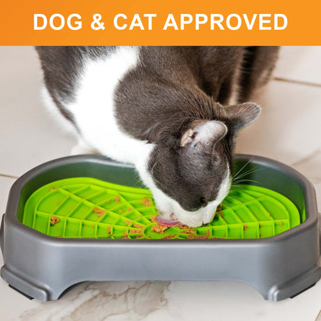 Cat licking food out of the Neat-Lik Mat Slow Feed Licking Mat with the base with text that says "Dog and cat approved."
