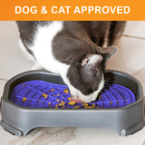 Cat licking food out of the Neat-Lik Mat Slow Feed Licking Mat with the base with text that says "Dog and cat approved."
