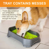A dog licking from a Neat Lik Mat with Tray. Bullets on the image call out that treats stay contained in the tray, the tray reduces chewing of the mat, and that it prevents pets from carrying the mat around the house.