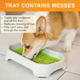 A dog licking from a Neat Lik Mat with Tray. Bullets on the image call out that treats stay contained in the tray, the tray reduces chewing of the mat, and that it prevents pets from carrying the mat around the house.