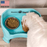 Goldendoodle eating from Aquamarine Neater Feeder Deluxe - Made in the USA