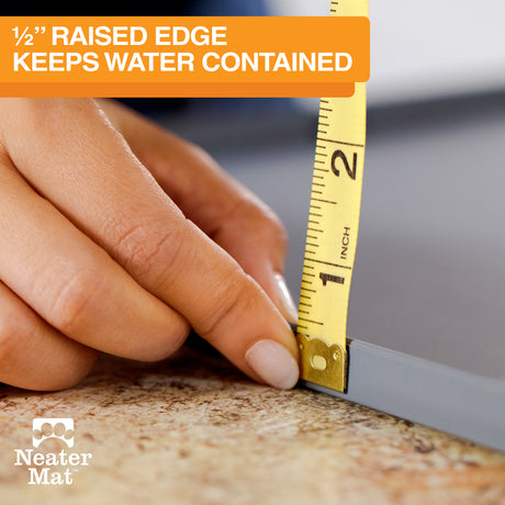 Hand using a tape measure on a Neater Mat with text about a 1/2" raised edge.