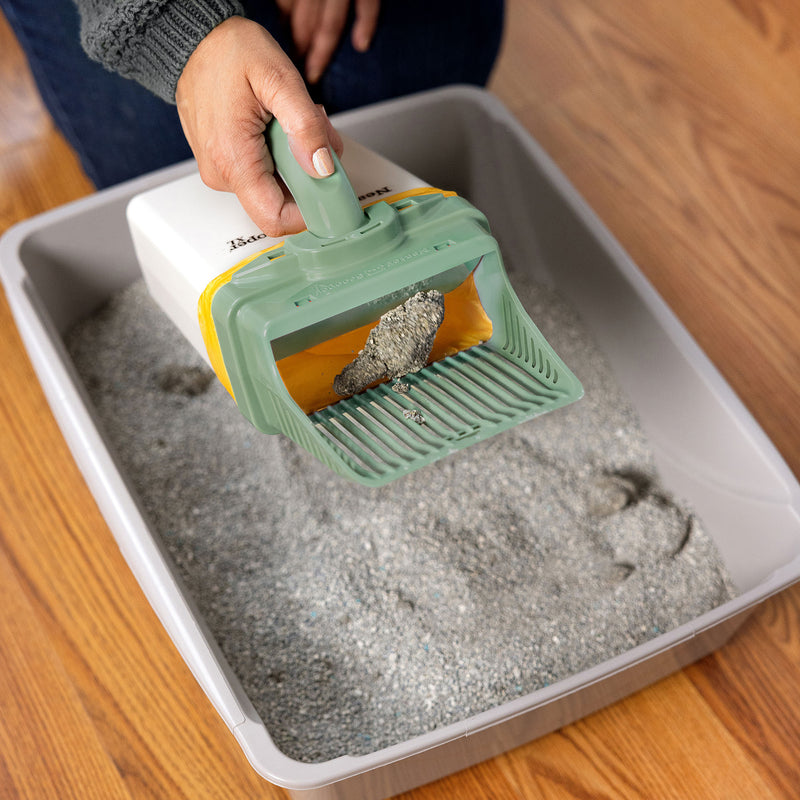 An image showing how the Neater Scooper XL works with the waste pushing open the trap door.