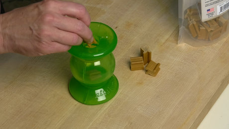 Picture showing someone putting hard treats into the Rolly Cannoli