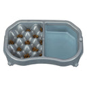 Neater Slow Feeder Double Diner with kibble and water inside the feeder against a white background.