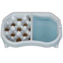 Neater Slow Feeder Double Diner in Vanilla Bean with kibble and water inside the feeder against a white background.