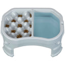 Raised Neater Slow Feeder Double Diner with kibble and water inside the feeder against a white background.